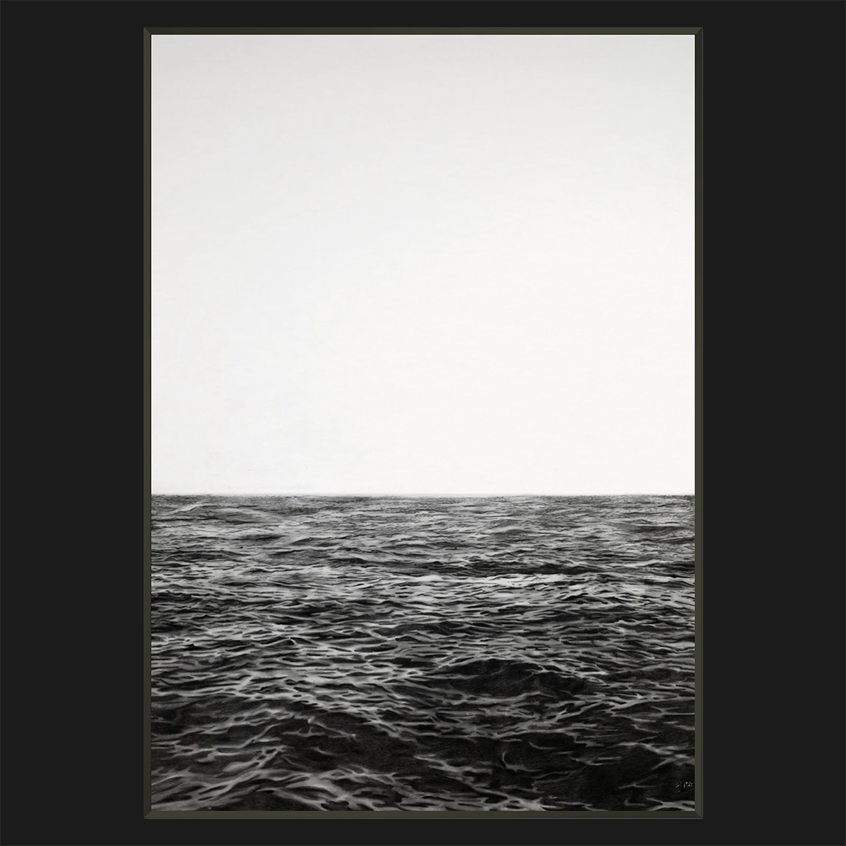 A framed minimalist black and white photorealistic drawing print depicting a calm ocean horizon under a pale, overcast sky, presented with a wide black border.