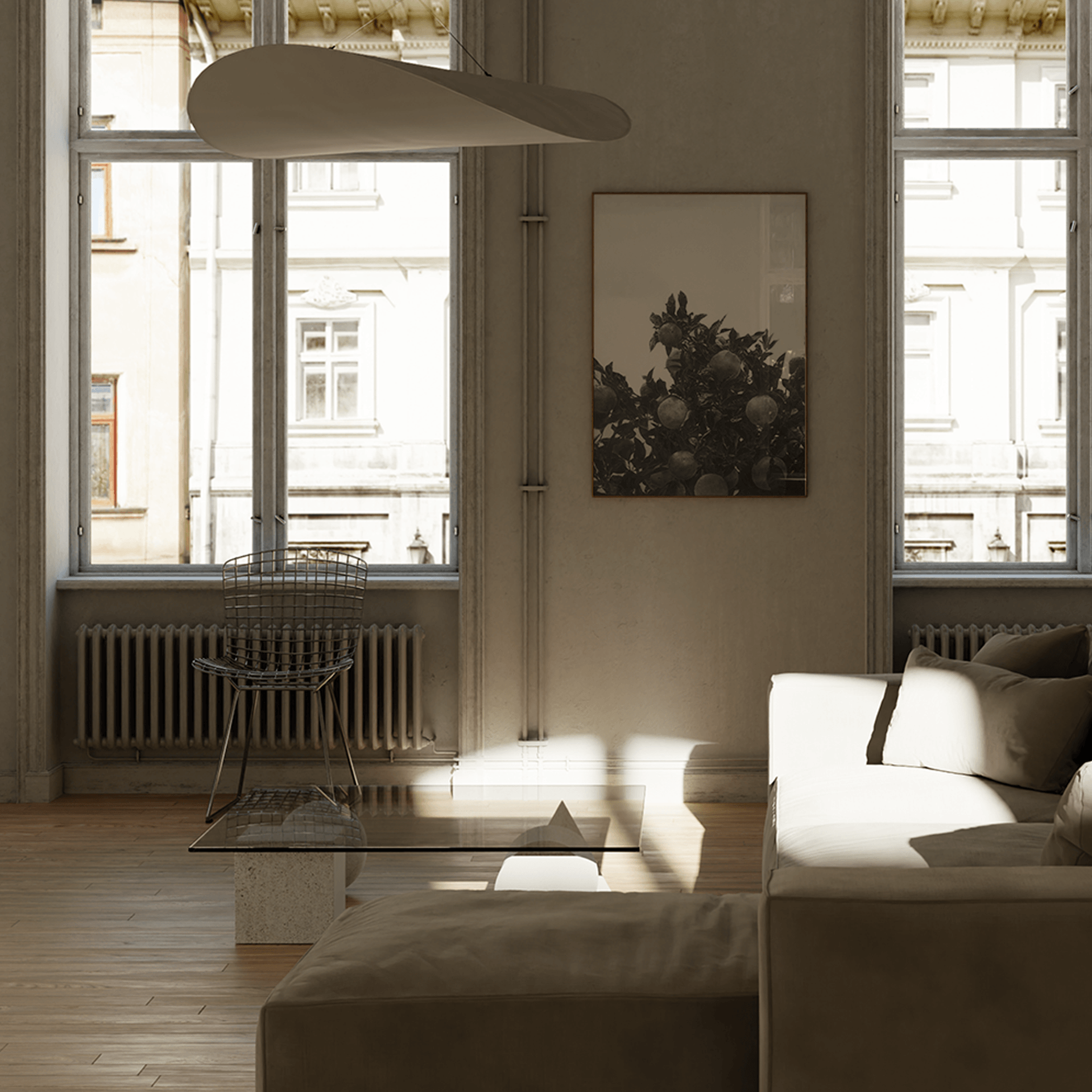 A large vertical framed art print featuring a black and white drawing of an orange tree, hanging on a textured wall in a modern, minimalist living room with a gray sofa and light wood flooring.