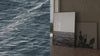 A side by side visual-on the right is Hyperrealistic charcoal art by Colorado artist Gillian Piña — fine art prints. On the left is a looping video of soft ocean waves.